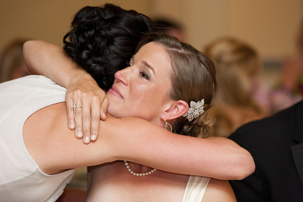Bride hugging a guest at the cerimony- wedding photo by top Canadian wedding photographer Rebecca Wood
